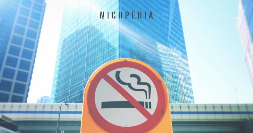 No smoking sign in front of a skyscraper, symbolising national efforts to reduce smoking