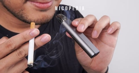 Man holds cigarette and a vape