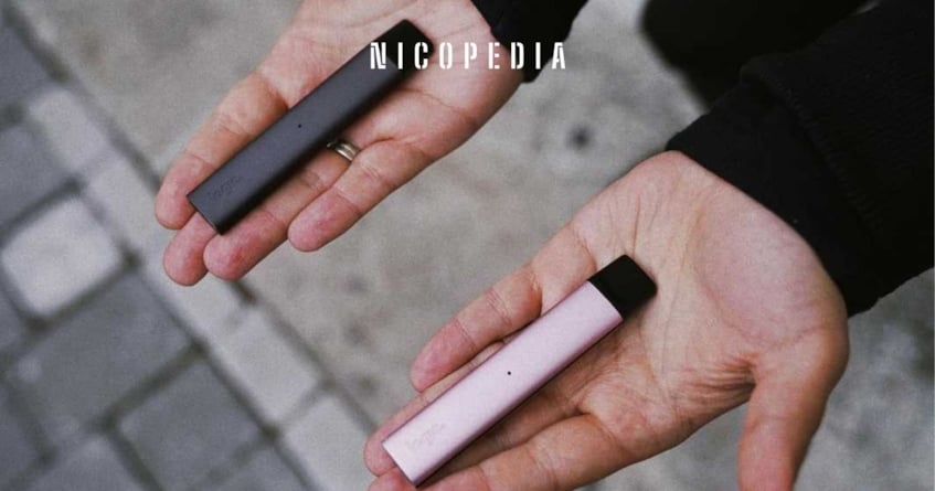 Person with outstretched hands, with a vape in each hand