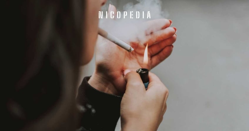 Women lights up a cigarette