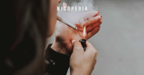 Women lights up a cigarette