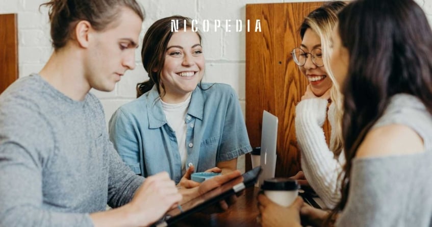 a group of people talking and smiling