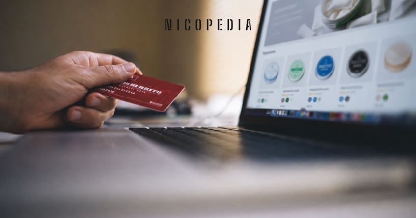person holding credit card while shopping online